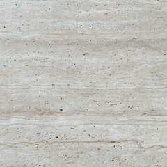 Fototapeta premium High-resolution close-up of natural light beige travertine stone texture with subtle horizontal layers, porous surface, and organic patterns. Elegant marble background.