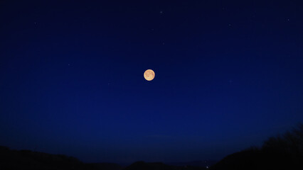 Full Moon, stars and planets above landscape silhouettes. © astrosystem