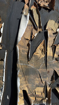 Weathered metal surface with cracked peeling paint and abstract industrial texture