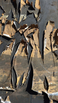 Weathered metal surface with cracked peeling paint and abstract industrial texture