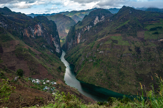 Scenic Mountain Valley with a River and Small Village in Vietnam's Ha Giand Loop, for Travel or Nature Projects - horizontal