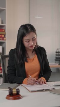Young asian female lawyer working in legal office