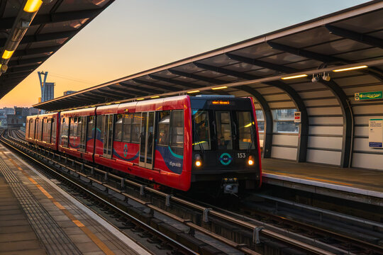 London, UK - 20 March, 2026 - Docklands Light Railway (DLR) train waiting at West Silvertown station platform during sunset