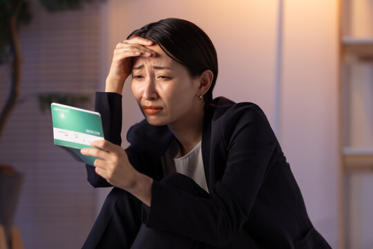 通帳を見る女性