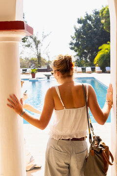 young woman vacation  by swimming pool