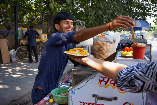 Young male vendor selling corn chat