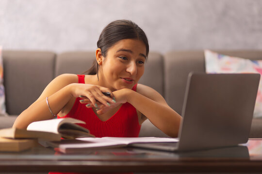 Portrait of a teenage girl having online class at home