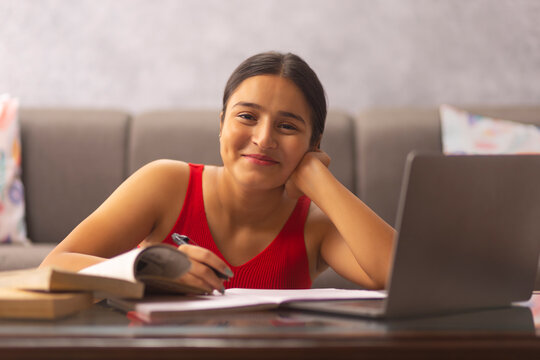 Portrait of a teenage girl having online class at home