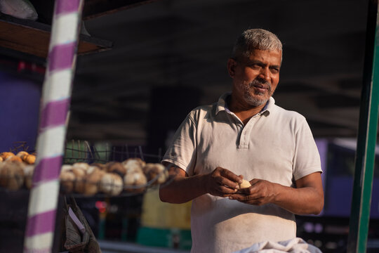Male vendor making dough for litti at his roadside food stall
