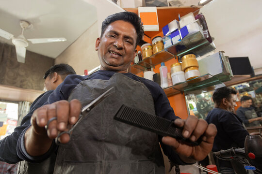 Portrait of a confident barber standing in his barber shop