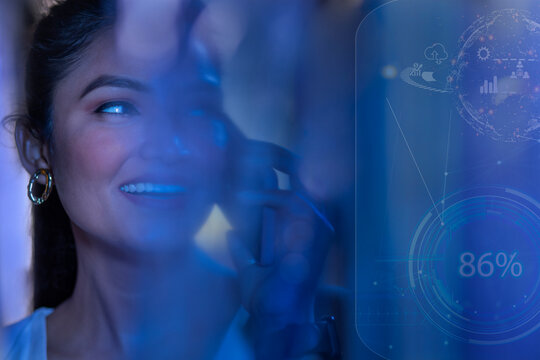 Businesswoman talking on smart phone with icons on virtual screen