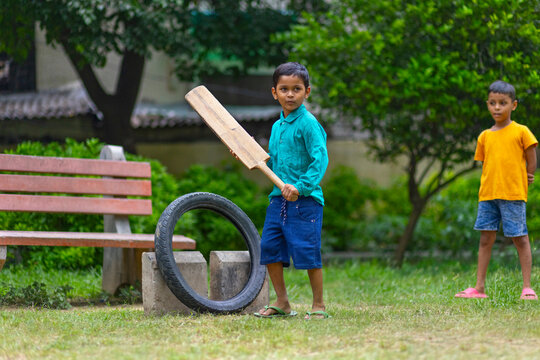 Portrait of boy playing cricket in the park