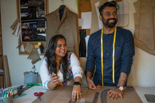 Fashion designers working on patterns in their studio 