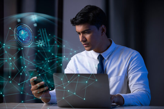 Businessman working on laptop computer with icons on virtual screen