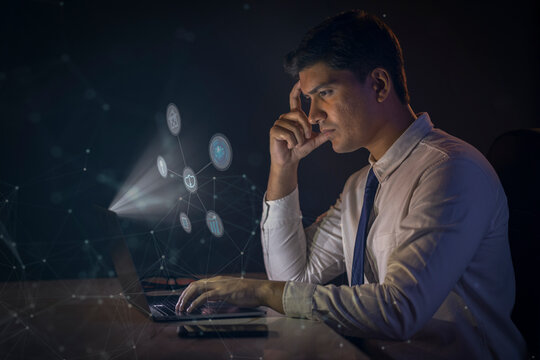 Young man using facial recognition technology with laptop