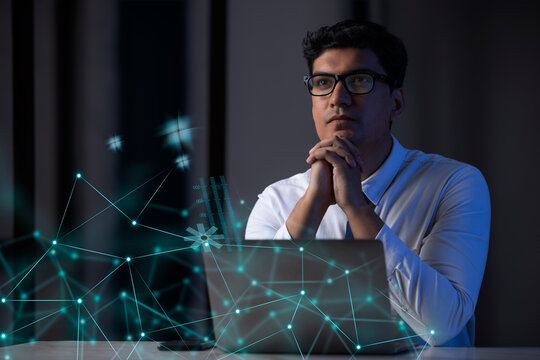 Businessman working on laptop computer with icons on virtual screen