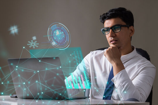 Businessman working on laptop computer with icons on virtual screen
