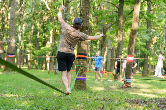 People practicing focus and finding mental balance together during a green outdoor community wellness workshop in a forest park