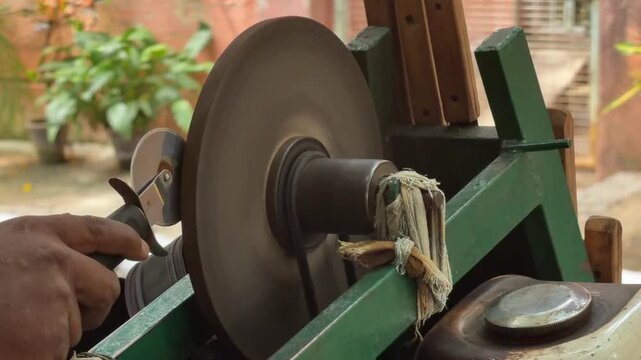Sharpening kitchen gadgets on rotating whetstone