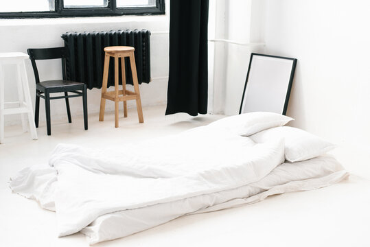 Minimalist White Bedding on Floor in Loft Bedroom