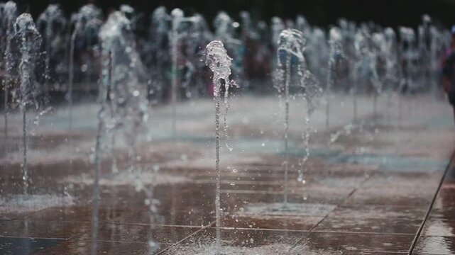 city fountain with splashing jet of clean transparent water, slow motion