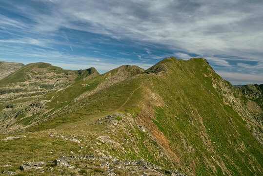 Pic de la Coma de Varilles and few other hills from GRP hiking trail above Estany de Cabana Sora hut in Pyrenees mountains in Andorra