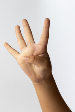 Child hand showing four fingers for kid counting number sign gesture
