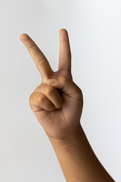 Child hand showing peace victory sign counting number two gesture