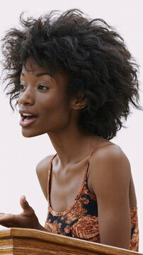 Confident African American Woman Delivering Engaging Speech at Corporate Event, Inspiring Empowerment and Connection Among Attendees
