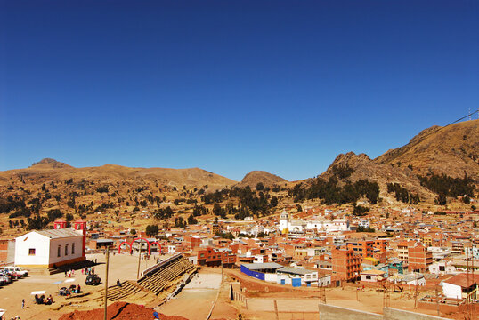 Bolivia, Copacabana, overview of the township of Copacabana, with the bright white Basilica home of the Virgin of Copacabana in the middle, with its belfry tower outstanding