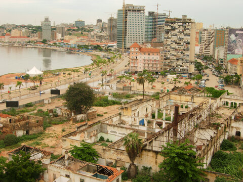 Africa, Angola, Luanda, elevated view of residential structures in cityscape with trees and lake