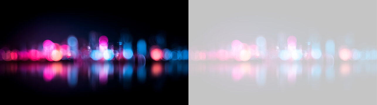 Blurred city lights bokeh effect with reflection. Abstract pink and blue light orbs on black and transparent background. Urban night life background