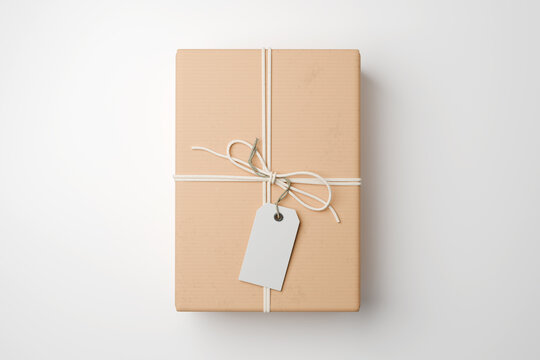 Gift box mockup wrapped in kraft paper texture with white string, vertical top view blank hang tag template on cardboard parcel package isolated on white background, present box, 3d render