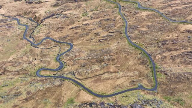 Epic Irish road trips car climbing The Healey Pass Cork road winding through the mountainside on The Wild Atlantic Way