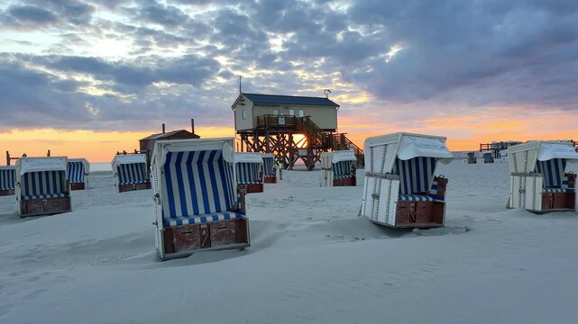 stilt house and beach chairs at the beach of Sankt Peter Ording