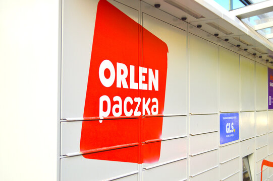 Modern automated self-service parcel locker terminal Orlen Paczka on a city street in Poland, providing convenient e-commerce package delivery and collection services.