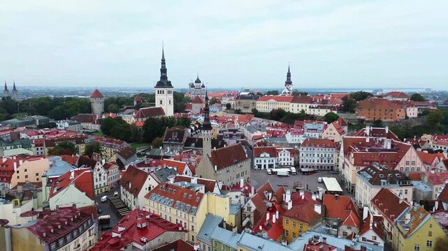 Exploring Tallin's colorful rooftops and historical buildings in Estonia's old town during a cloudy afternoon