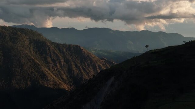 Aerial drone footage over a lush green valley in Sillar de los Indios, Constanza, Dominican Republic