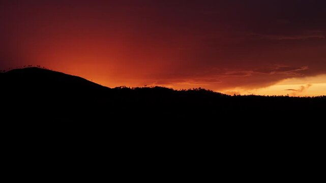 Cinematic aerial drone footage of a breathtaking sunset over the mountain landscape of Valle Nuevo National Park in Constanza, Dominican Republic.