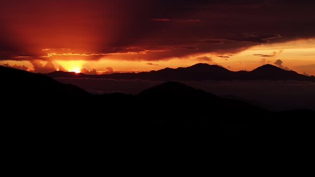 Cinematic aerial drone footage of a breathtaking sunset over the mountain landscape of Valle Nuevo National Park in Constanza, Dominican Republic.