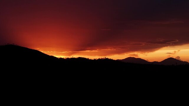 Cinematic aerial drone footage of a breathtaking sunset over the mountain landscape of Valle Nuevo National Park in Constanza, Dominican Republic.