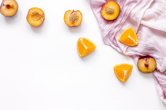 woman summer breackfast with orange and peach fruits and fabric on white background flat lay mockup