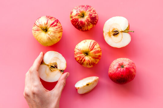 Red apples pattern on pink background top view