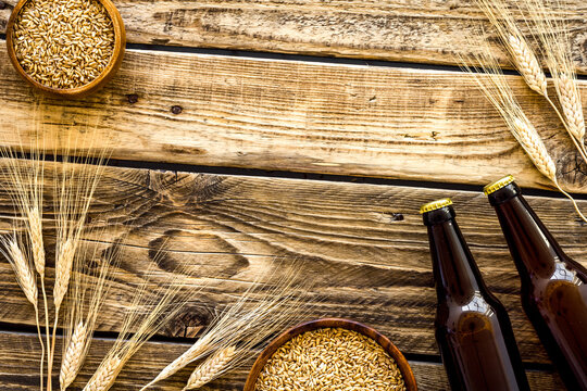 Beer background with barley on rustic wooden background top view copy space