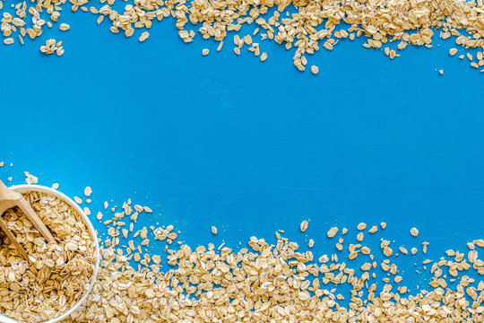 Oatmeals background on blue table top view frame copy space