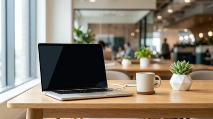 Fototapeta premium Laptop computer with blank screen on wooden office desk with coffee mug