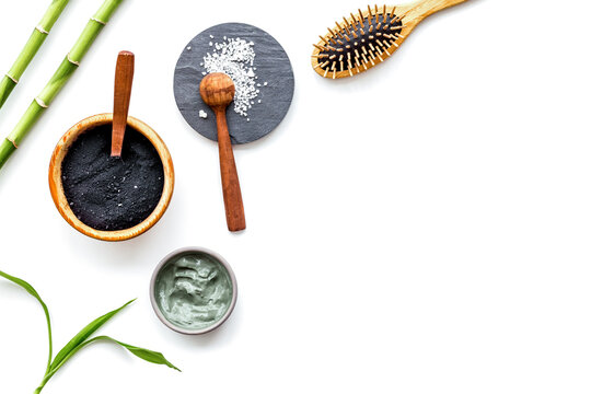 Skin cleansing and detox. Bamboo charcoal powder cosmetics on white background top view copy space