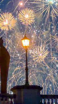 Spectacular fireworks display illuminating night sky above vintage lantern at Steenplein in Antwerpen, Belgi&euml;