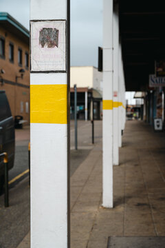 Corby, Northamptonshire, United Kingdom - July 15, 2026: Covered walkway with white columns and yellow safety markings