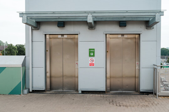 Corby, Northamptonshire, United Kingdom - July 15, 2026: Modern stainless steel elevators at multi storey car park entrance